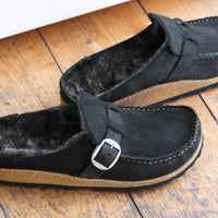Detail view of Birkenstock Buckley with genuine Shearling lining in soft suede black. Matte silver hardware detail and adjustable strap.
