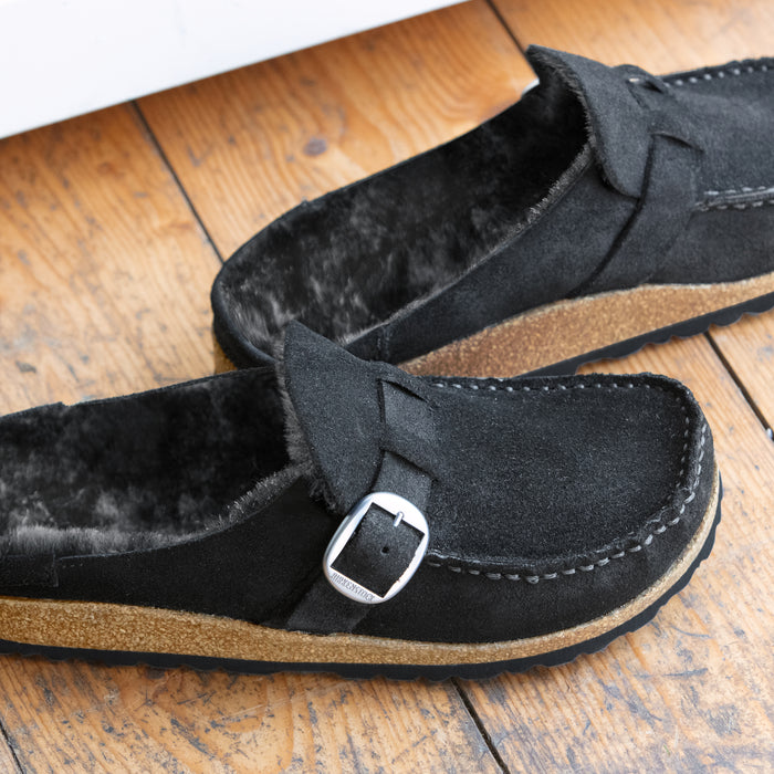 Detail view of Birkenstock Buckley with genuine Shearling lining in soft suede black. Matte silver hardware detail and adjustable strap.