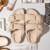 Overhead view of plush teddy shearling Birkenstock Arizona Big Buckle sandal with oversized metal pin buckles.