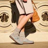 Women's Birkenstock Buckley Shearling in Stone Coin Suede Leather - Lifestyle image of woman wearing