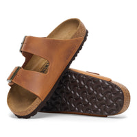 Profile view of the classic Cognac brown oiled leather Arizona sandal by Birkenstock featuring original footbed and unique oiled finish.