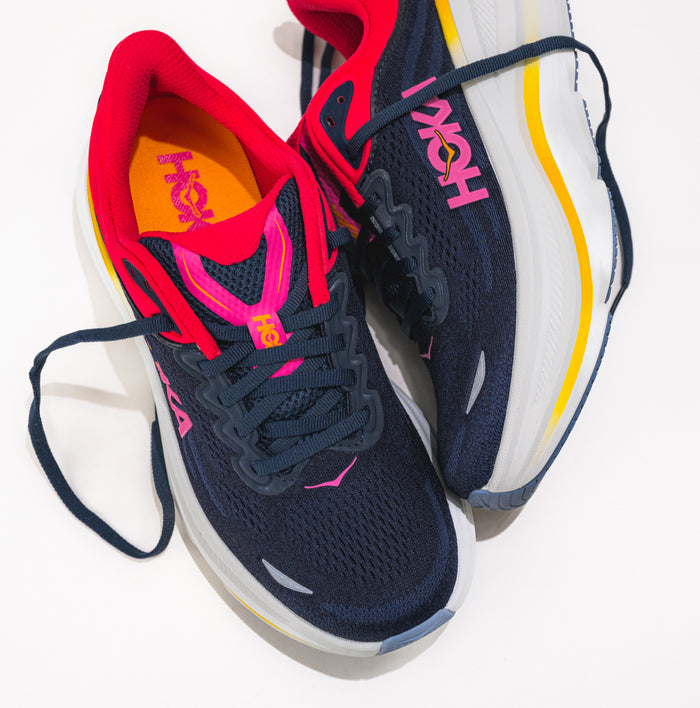 Navy and red sneakers with colorful accents on a white background.
Women's HOKA Bondi 9 Running Shoe in Varsity Navy/Nautical Dusk