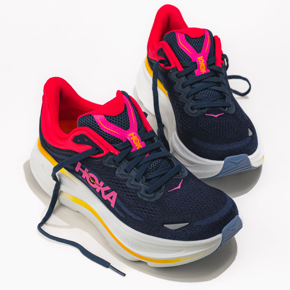 Navy and red running shoes with colorful accents on a white background.
Women's HOKA Bondi 9 Running Shoe in Varsity Navy/Nautical Dusk