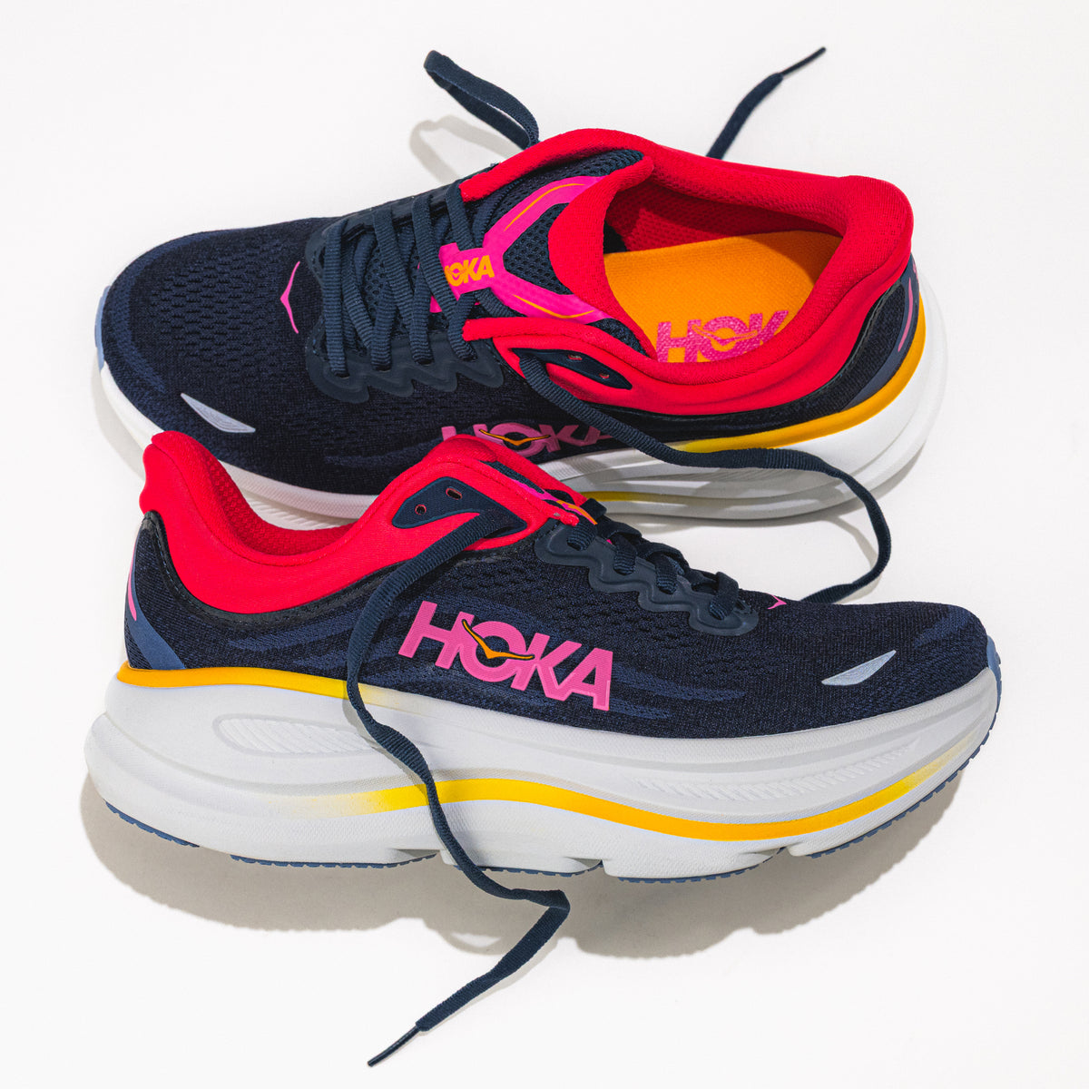 Navy and red Hoka running shoes on a white background.
Women's HOKA Bondi 9 Running Shoe in Varsity Navy/Nautical Dusk