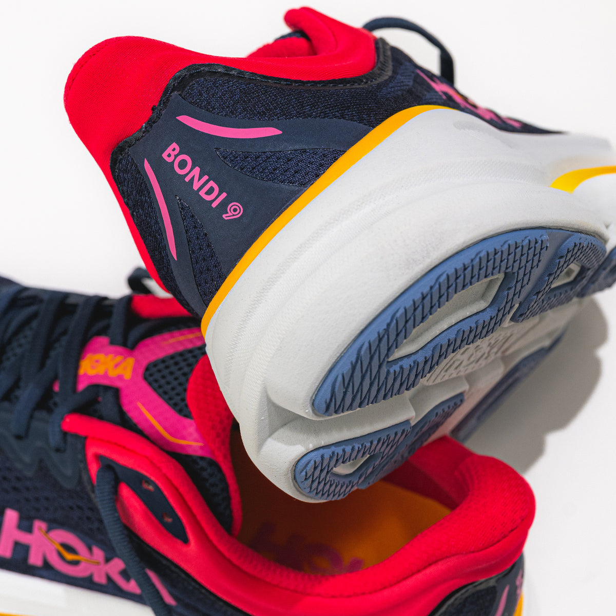 Colorful athletic shoe with 'BONDI' and 'HOKA' branding on a white background.
Women's HOKA Bondi 9 Running Shoe in Varsity Navy/Nautical Dusk