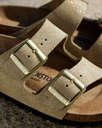 Birkenstock Arizona Sandal in Shimmering Taupe Suede.
Birkenstock Arizona sandal, shimmering taupe suede, iconic two-strap sandal, women’s comfort sandals, cork footbed sandals.