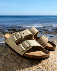 Birkenstock Arizona Sandal in Shimmering Taupe Suede.
Birkenstock Arizona sandal, shimmering taupe suede, iconic two-strap sandal, women’s comfort sandals, cork footbed sandals.