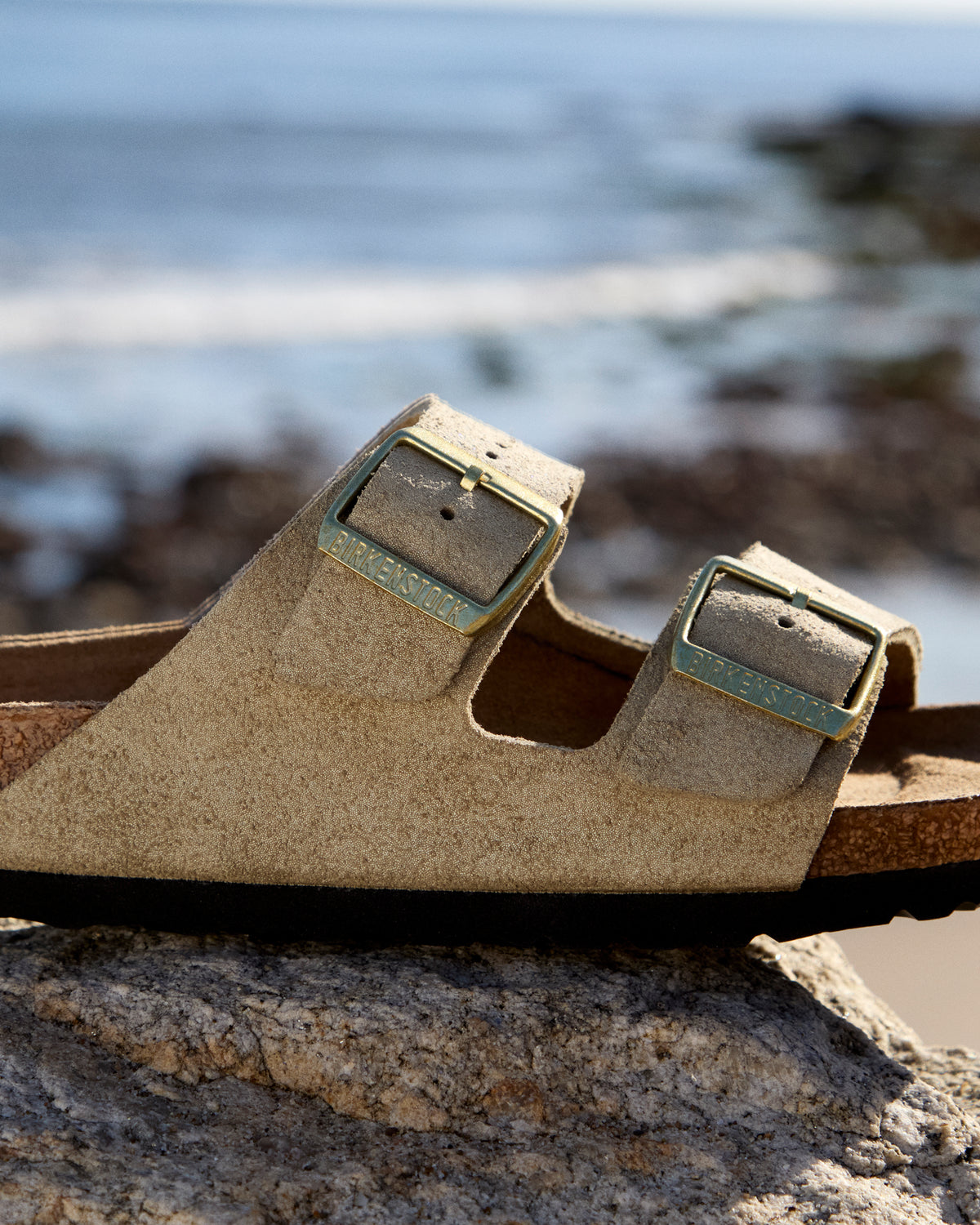 Birkenstock Arizona Sandal in Shimmering Taupe Suede.
Birkenstock Arizona sandal, shimmering taupe suede, iconic two-strap sandal, women’s comfort sandals, cork footbed sandals.