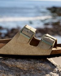 Birkenstock Arizona Sandal in Shimmering Taupe Suede.
Birkenstock Arizona sandal, shimmering taupe suede, iconic two-strap sandal, women’s comfort sandals, cork footbed sandals.