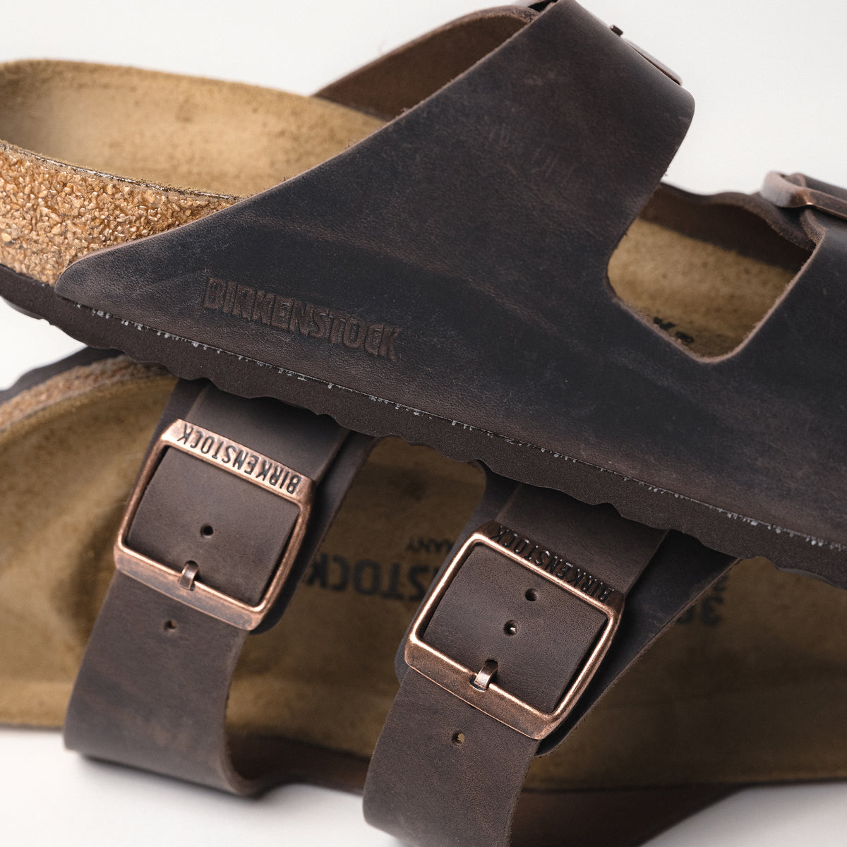 Close-up of the front view of the Birkenstock Arizona Sandal in Habana Oiled Leather, showcasing the iconic dual-strap design with adjustable metal buckles.