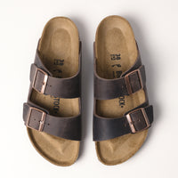 Top view of the Birkenstock Arizona Sandal in Habana Oiled Leather, highlighting the contoured cork-latex footbed and timeless craftsmanship.