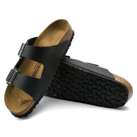 Detail view of the contoured footbed and textured sole on the Birkenstock Arizona Sandal in Black Oil Leather, unisex sizing.