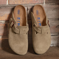 Birkenstock Boston Soft clog in Taupe Suede, featuring premium suede leather for all-day comfort. Classic slip-on style with soft footbed support, ideal for casual wear, gardening, or daily errands. Durable, lightweight, and built for long-lasting use, perfect for men and women seeking comfort and trendiness in footwear.