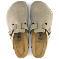Pair of taupe Birkenstock clogs on a white background.
Birkenstock Boston Soft clog in Taupe Suede, featuring premium suede leather for all-day comfort. Classic slip-on style with soft footbed support. Durable, lightweight, and built for long-lasting use, perfect for men and women seeking comfort and trendiness in footwear.