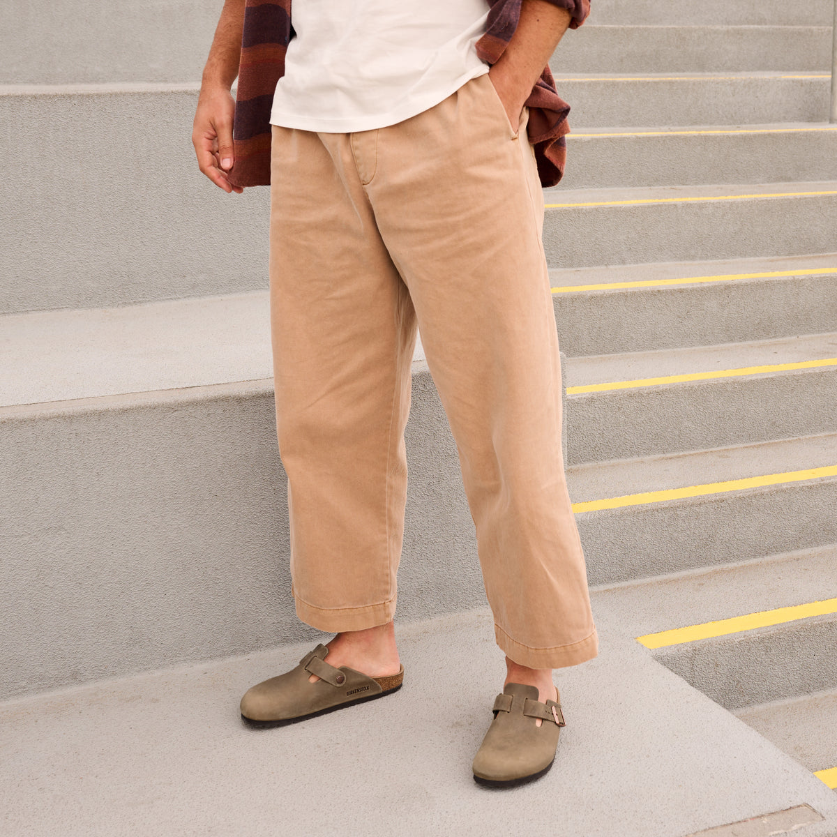 Lifestyle shot of male wearing the Birkenstock Boston Clog in Tobacco Oiled Leather a unisex slip on style