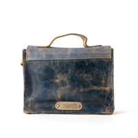 Rear view of the BED|STU Improv Handbag in vegetable-tanned leather, showcasing its compact rectangular shape, stylish design and logo patch.