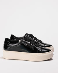 Side profile of Aetrex Aubrey sneaker in glossy black patent leather with cream platform sole