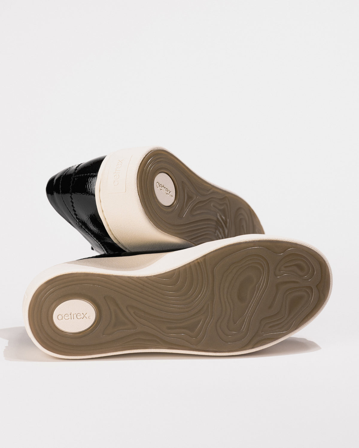 Outsole view of Aetrex Aubrey sneaker showing tread pattern and Aetrex branding