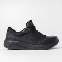 Side profile of the New Balance 928 V3 Stable Walking Shoe in black leather, featuring the ROLLBAR stability technology for rear-foot motion control.