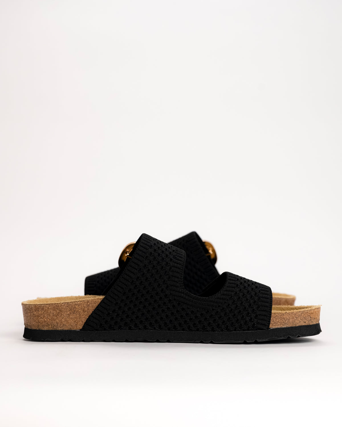 Side profile of Naot Miami sandal in black showing EVA sole and footbed on white background