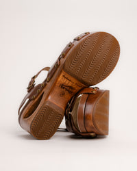 The Dansko Alanna in Tan leather is a standout piece from Dansko’s Ashland collection, designed for those who want a high-fashion silhouette without the usual discomfort of a tall heel. Every pair is handmade in Brazil, featuring a genuine wood wedge that has been hand-carved, sanded, and flame-burnished for a one-of-a-kind finish. The sculpted 3.5-inch heel is balanced by a 1.5-inch platform, creating a manageable 2-inch effective slope that provides height while maintaining stability.