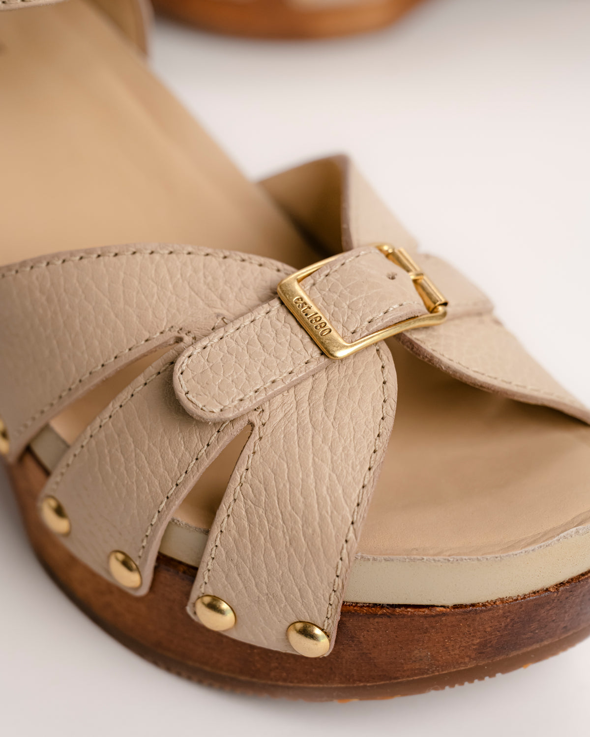 Luxe detail, golden buckle on the Dansko Alanna Wood Wedge sandal in Vanilla leather 