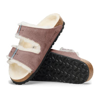 Side and bottom detail view of the Birkenstock Arizona sandal in Faded Purple featuring a soft genuine shearling lining, adjustable 2-strap design and cork and latex footbed.