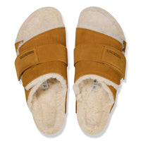 Overhead detail of the cork latex BIRKENSTOCK footbed with genuine shearling lining on the cozy Birkenstock Kyoto Shearling in Brown Suede Leather slip-on sandal with adjustable hook and loop strap.