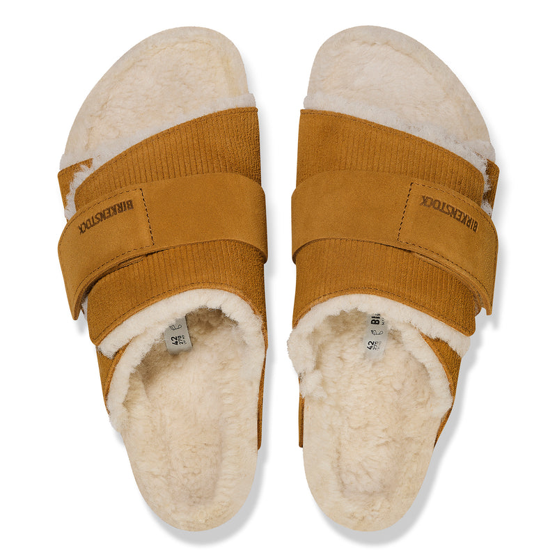 Overhead detail of the cork latex BIRKENSTOCK footbed with genuine shearling lining on the cozy Birkenstock Kyoto Shearling in Brown Suede Leather slip-on sandal with adjustable hook and loop strap.