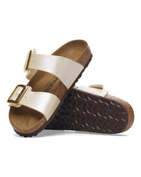 Pair of Birkenstock Sydney Luxe Buckle sandals with metallic strap on a white background