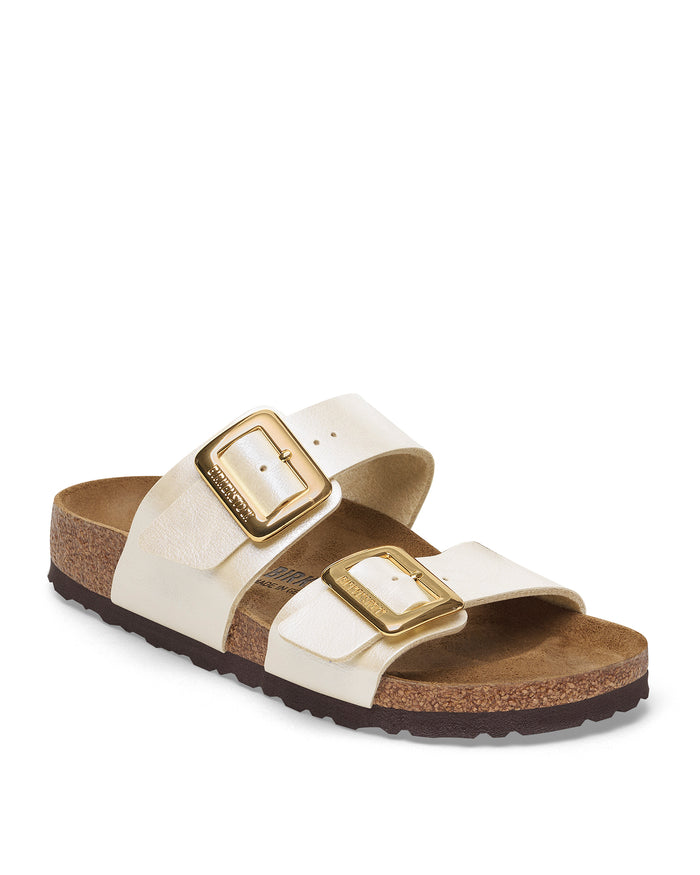 Pearl white Birkenstock Sydney Luxe Buckle sandal with gold buckles on a white background