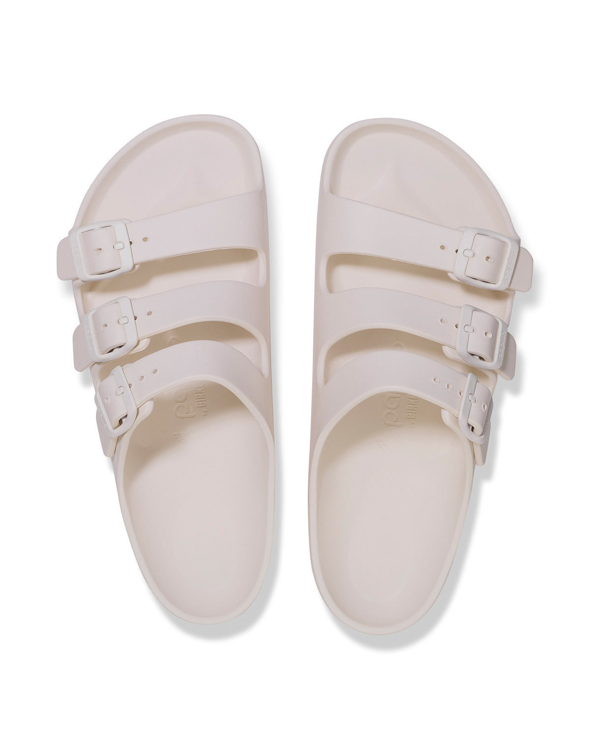 Pair of Birkenstock EVA Florida Flex Platform Sandals in Eggshell with three straps on a white background