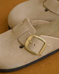 Birkenstock Boston Big Buckle Clog in Brown Oiled Leather – Heritage Comfort

The Boston Big Buckle brings a bold, premium hardware statement to a Birkenstock most-coveted classic slip-on clog. The seamless upper is built with substantial heritage oiled leather, measuring a rugged 2.8 to 3.2 millimeters in thickness. This premium hide features an untreated, oily-waxed surface finish that yields rich, organic color variations with every individual pair. It is designed to develop a personalized, vinta