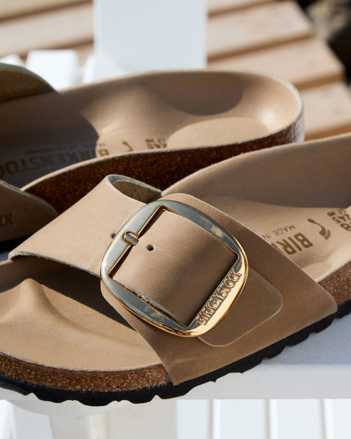 Birkenstock Madrid Big Buckle Sandal in Tan Tabacco Oiled Leather with a gold buckle on a white surface