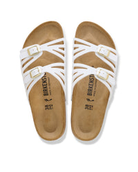 For those who like the classic Birkenstock feel but want something a bit more decorative, the Granada is the perfect middle ground. It features a unique double-strap design with laser-cut detailing that gives it a lighter, more airy appearance than the chunkier traditional models. It’s a great way to get that signature supportive feel in a silhouette that looks right at home with summer dresses and skirts. Shown in White synthetic Birko-Flor.