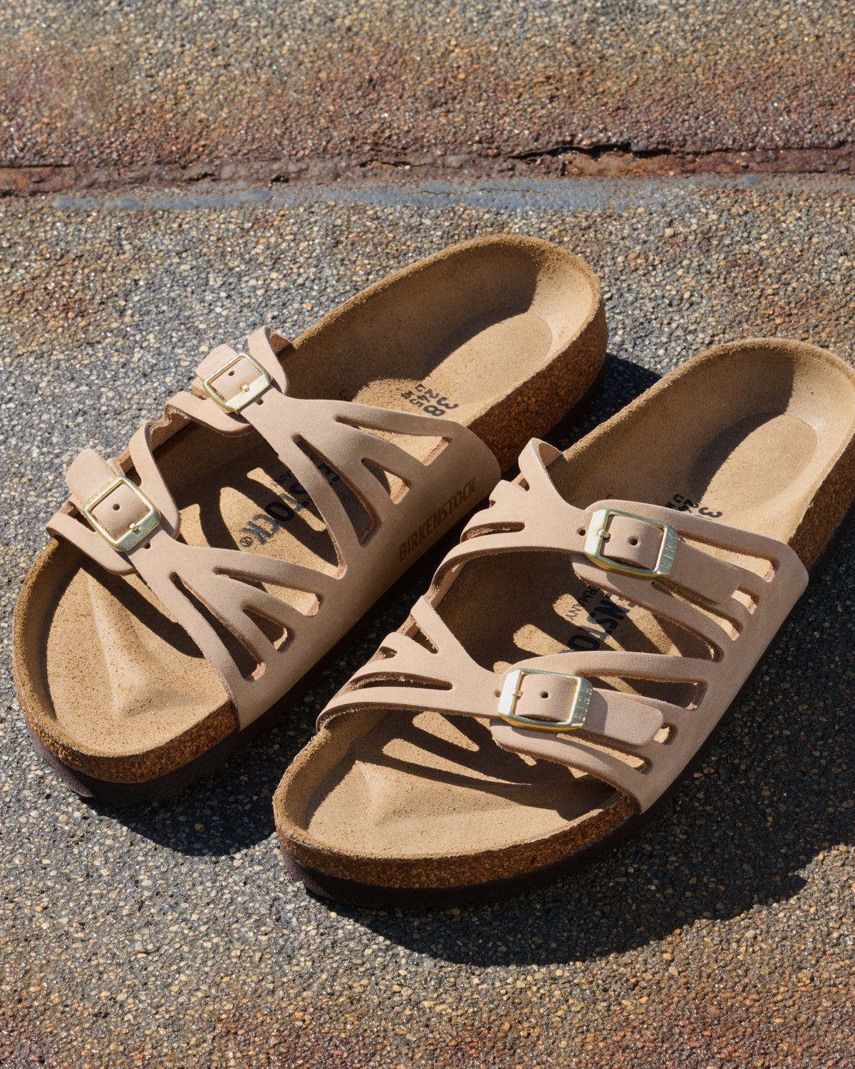 The Birkenstock Granada offers a refined, natural aesthetic for those who appreciate the support of a classic slide but want a more detailed look. This version is upgraded with premium nubuck leather, which is gently buffed to create a soft, velvety texture that feels luxurious from the first wear. The twin-strap design features elegant laser-cut perforations, providing a light and airy feel that transitions perfectly from a casual day out to a more put-together summer evening.