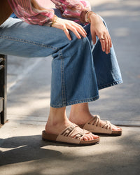 The Birkenstock Granada offers a refined, natural aesthetic for those who appreciate the support of a classic slide but want a more detailed look. This version is upgraded with premium nubuck leather, which is gently buffed to create a soft, velvety texture that feels luxurious from the first wear. The twin-strap design features elegant laser-cut perforations, providing a light and airy feel that transitions perfectly from a casual day out to a more put-together summer evening.