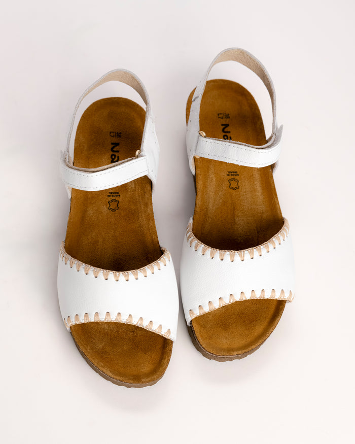 Top view of Naot Luna sandal showing contrast stitching detail on the white leather upper