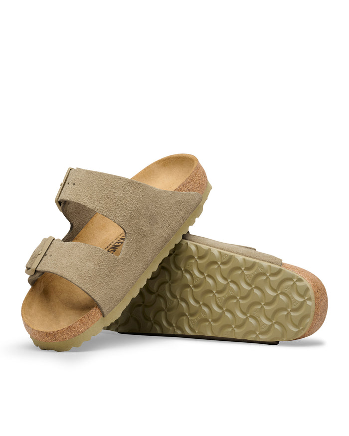 Pair of beige Birkenstock Arizona sandals in Faded Khaki colored suede on a white background