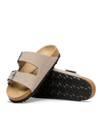 The Birkenstock Arizona is essentially the gold standard for slides, and this Birkibuc version is the practical answer for anyone who wants a rugged, low-maintenance look. Instead of traditional leather, these are crafted from a signature Birkenstock material called Birkibuc—a heavy-duty synthetic with a brushed finish that mimics the texture of real nubuck. It’s tough, easy to wipe down, and holds its shape through seasons of wear.