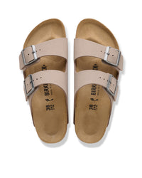 The Birkenstock Arizona is essentially the gold standard for slides, and this Birkibuc version is the practical answer for anyone who wants a rugged, low-maintenance look. Instead of traditional leather, these are crafted from a signature Birkenstock material called Birkibuc—a heavy-duty synthetic with a brushed finish that mimics the texture of real nubuck. It’s tough, easy to wipe down, and holds its shape through seasons of wear.