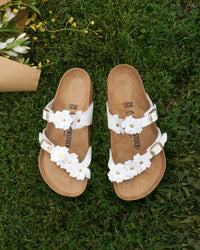 Garden party must-have. The Mayari Flowers takes that classic, secure toe-loop design we all love and dresses it up with sweet leather floral appliqués.&nbsp;A slightly more "feminine" take on the utility look, making it easy to pair with sundresses or cropped denim without feeling too sporty.