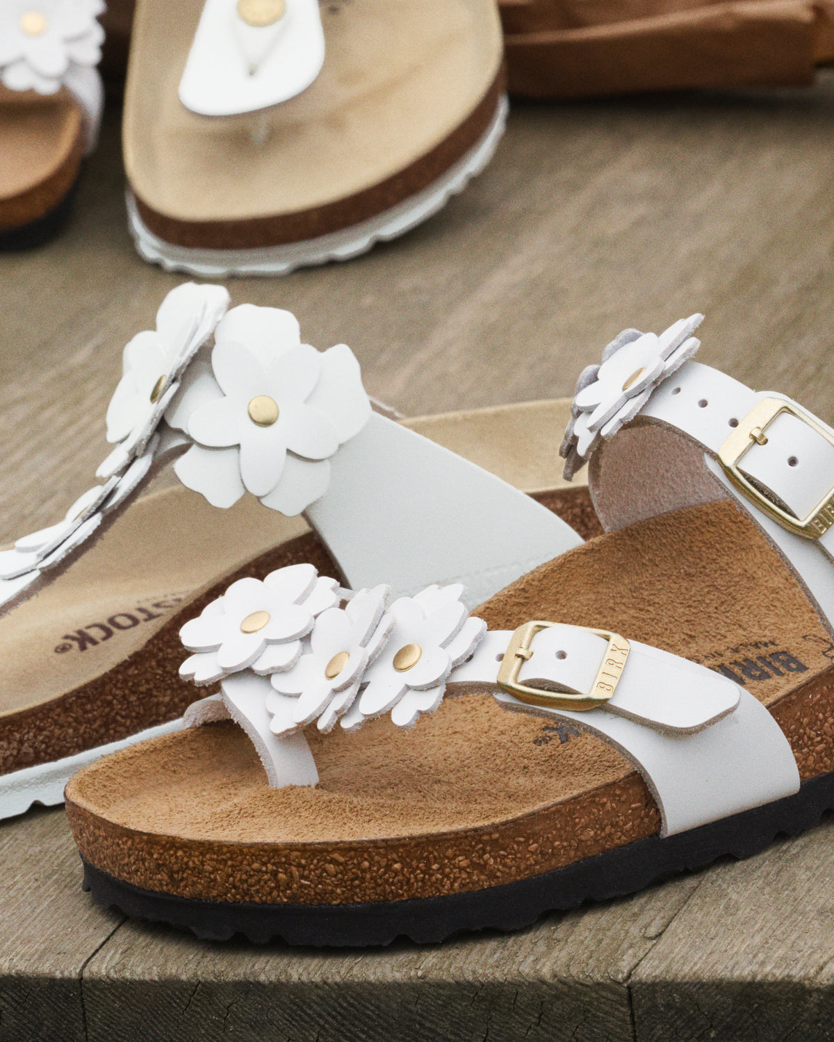 The Mayari Flowers takes that classic, secure toe-loop design we all love and dresses it up with sweet leather floral appliqués.&nbsp;A slightly more "feminine" take on the utility look, making it easy to pair with sundresses or cropped denim without feeling too sporty.