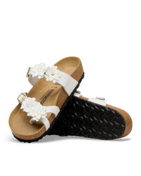 The Mayari Flowers takes that classic, secure toe-loop design we all love and dresses it up with sweet leather floral appliqués.&nbsp;A slightly more "feminine" take on the utility look, making it easy to pair with sundresses or cropped denim without feeling too sporty.