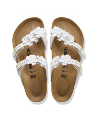 The Mayari Flowers takes that classic, secure toe-loop design we all love and dresses it up with sweet leather floral appliqués.&nbsp;A slightly more "feminine" take on the utility look, making it easy to pair with sundresses or cropped denim without feeling too sporty.