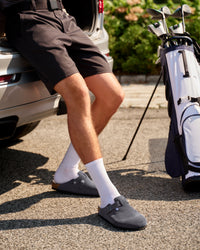 Person sitting by a car with a golf bag and clubs, wearing dark shorts and Birkenstock Boston Soft Footbed Suede Leather Clog in Charcoal

The Birkenstock Boston Clog has transitioned from a lounge staple to a street-style icon, and this version offers the most "broken-in" feel right out of the box. Crafted from premium, velvety suede, the upper has a soft, flexible drape that conforms comfortably to the foot. The standout feature is the integrated latex foam layer tucked inside the signature cork footbed. 