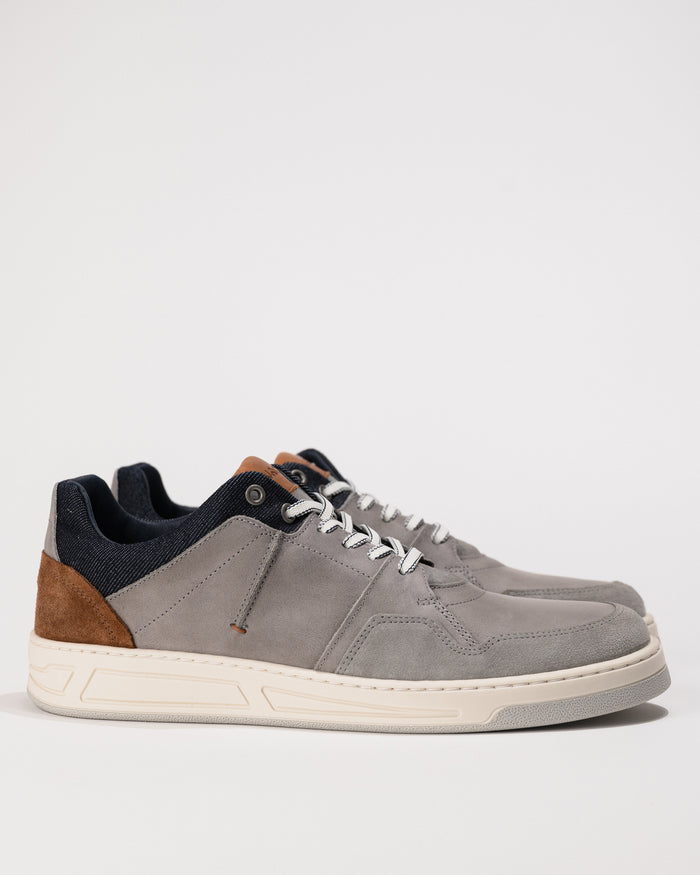 Gray sneaker with brown accents on a white background