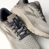 Close-up of the Brooks logo and stylish details on the Ghost 16 in Falcon/Coconut accents.