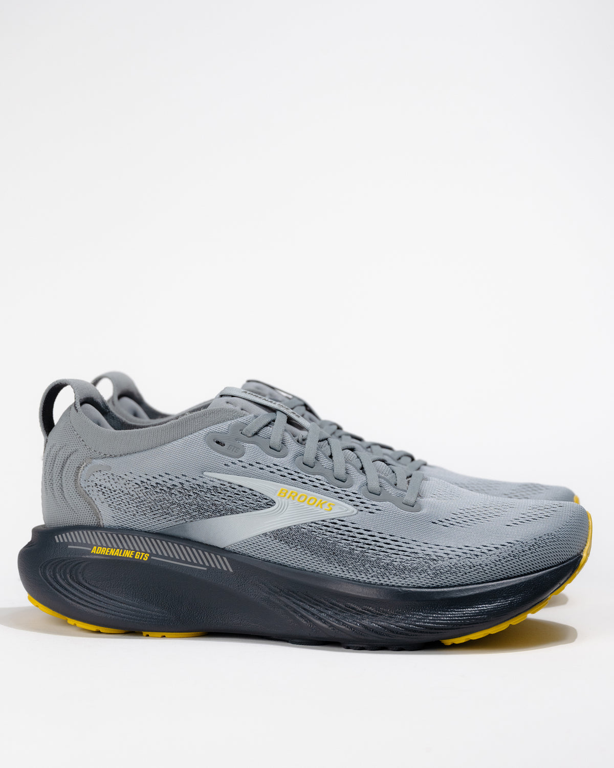 Men’s Brooks Adrenaline GTS 25 Primer Gray running shoe – angled side profile view showing GuideRails support and engineered mesh upper