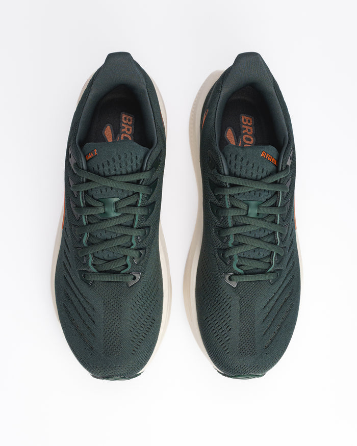A pair of Brooks Glycerin Max 2 running shoes in dark forest green with orange accents on the tongue and side, shown from a top-down view on a white background.